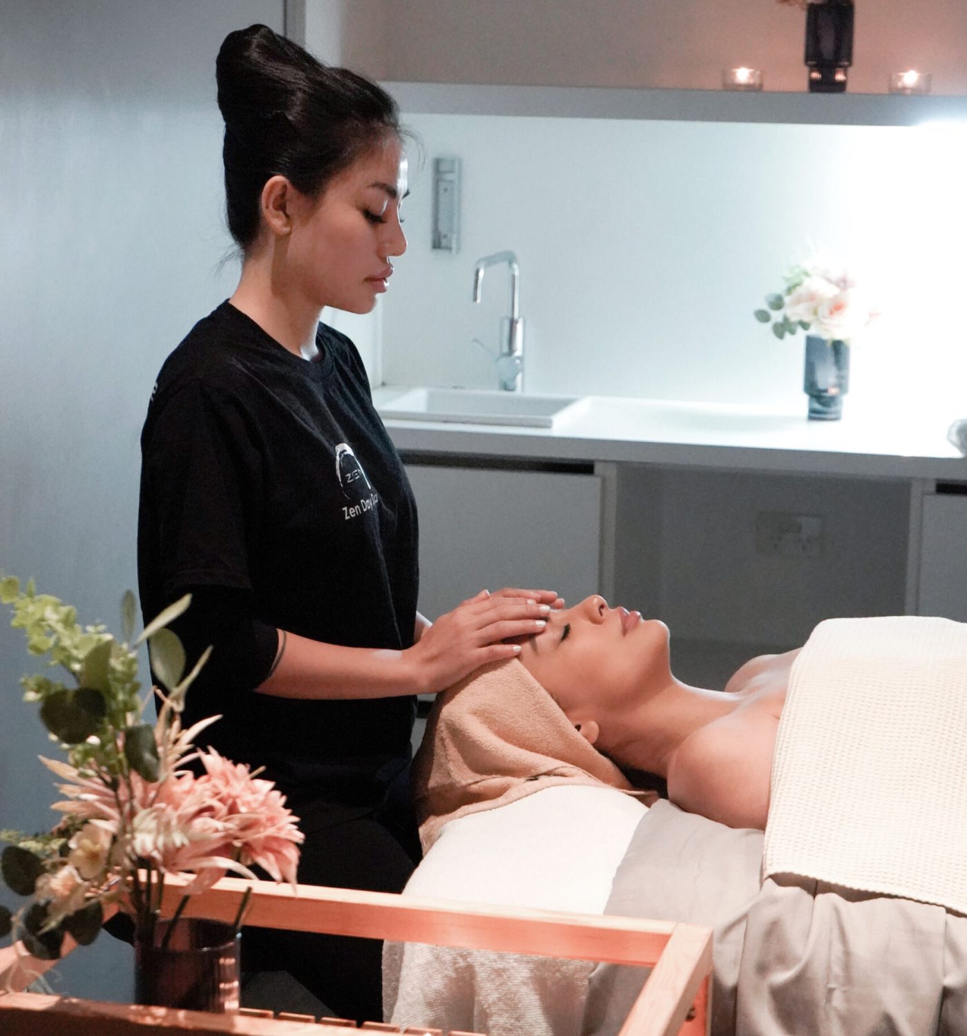 Zen Day Spa therapist performing a relaxing facial treatment