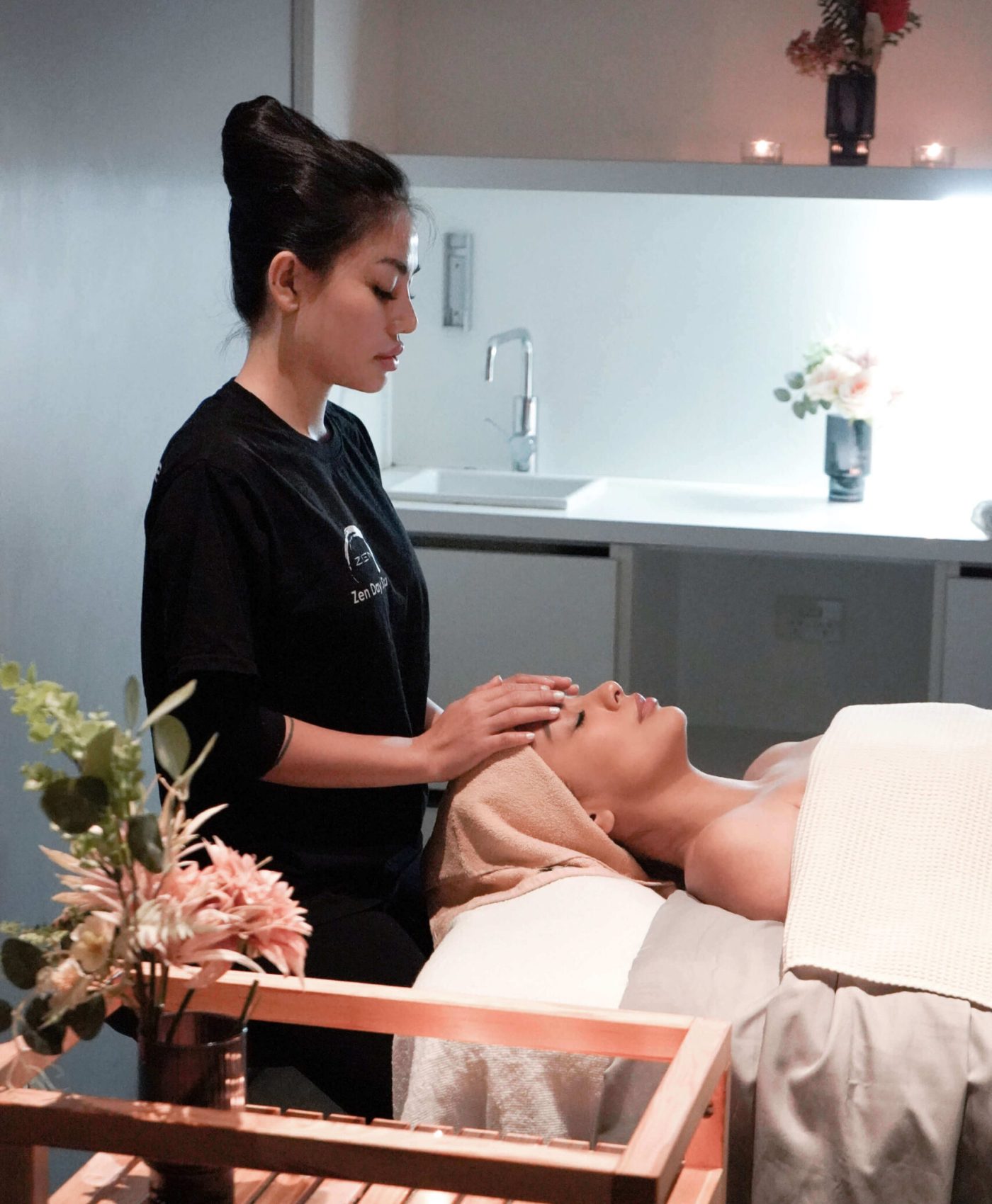 Zen Day Spa therapist performing a relaxing facial treatment